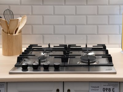 Modern hob gas stove countertop in big kitchen interior.