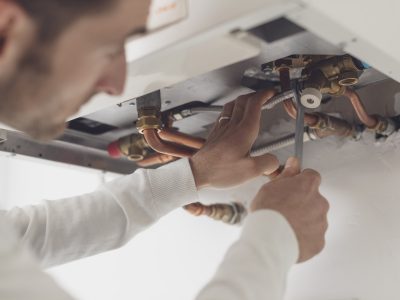 Professional plumber checking a boiler