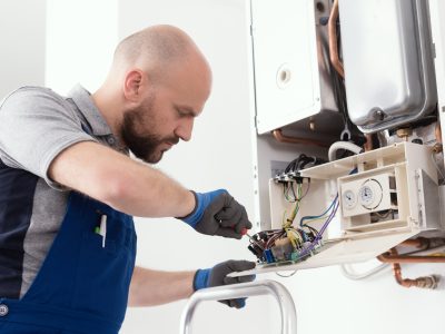 Qualified engineer servicing a boiler